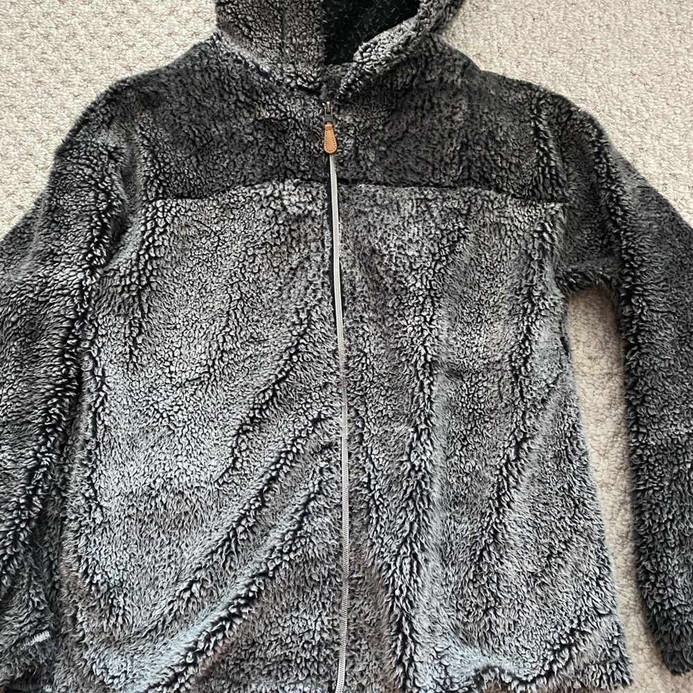 Medium, long sleeve black and grey sherpa jacket.